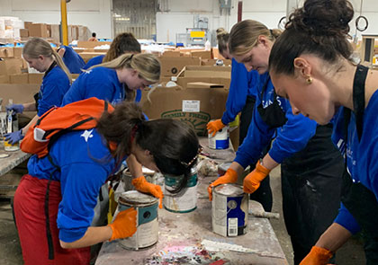 Students working to reuse paint during Saints Serve 2024