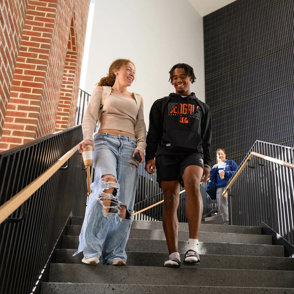 Students walking down the staircase of the Academic Center.