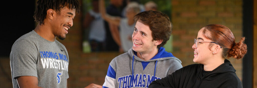 Thomas More students interacting in a common area of the residence hall